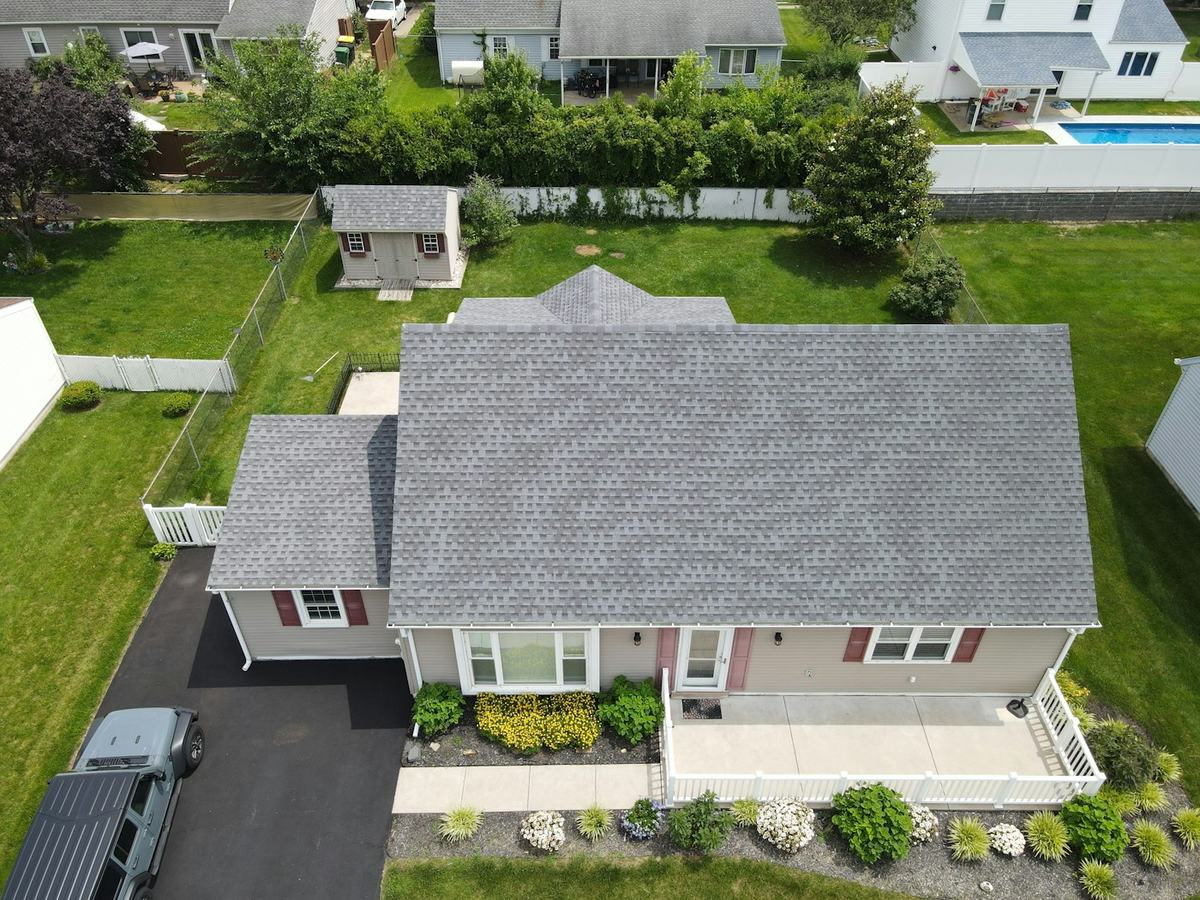Home with an architectural shingle roof and gutters